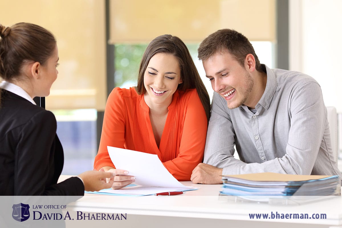 Credit after bankruptcy - young couple meeting with loan officer.